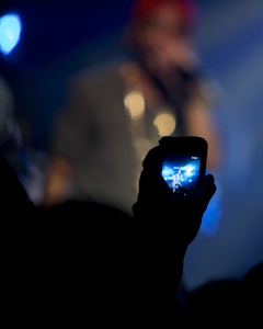 Big Sean is seen through the camera of a member of the crowd. 