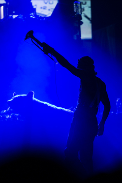 Owuor Arunga, one of Macklemore's band members, is silhouetted in between songs.