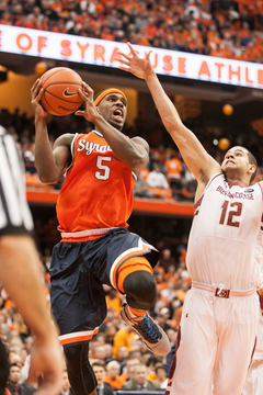 Fair goes up for a layup while Anderson reaches out for a block. 