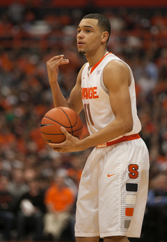 Ennis motions to his teammates Monday night. The point guard struggled to score, but dished out eight assists.