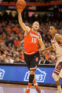 Trevor Cooney throws a pass upcourt with Olivier Hanlan guarding him. 