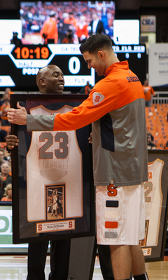 Russ DeRemer collects his Senior Day jersey from Athletic Director Daryl Gross. 