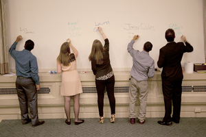 Prospective general assembly candidates write their name and major on the board in preparation for questioning.prior to the vote.