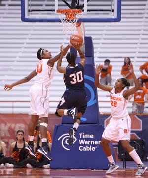 Kayla Alexander blocks a shot on Fairleigh Dickinson Danielle Pankey in Syracuse's 94-47 win on Sunday. Alexander scored 20 points, grabbed 10 rebounds and had eight steals in the game.