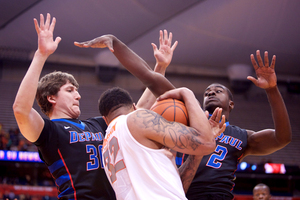 Syracuse forward DaJuan Coleman gets swarmed by a pair of DePaul defenders. The Orange knocked down 24 free throws as a team in its win over the Blue Demons.