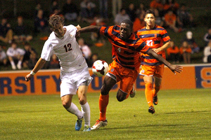 Syracuse defender Jordan Murrell jostles for position against Virginia's Riggs Lennon.