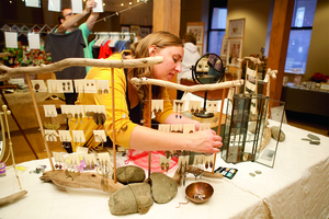 Laurel of Laurel O'Brien Jewelry arranges her handcrafted, artisan jewelry at the 2012 Salt Market. 