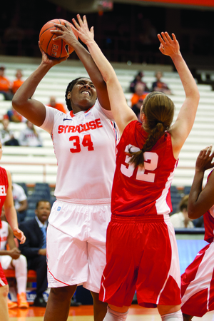 Syracuse center Shakeya Leary muscles her way through Cornell forward Nicholle Aston.