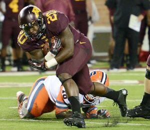 Donnell Kirkwood runs by Syracuse's Siriki Diabate in Minnesota's 17-10 win over the Orange. 