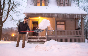 Ian Teti, a senior in the S.I. Newhouse School of Public Communications, shovels snow on Ostrom Avenue. Under the proposed ordinance, which the Common Council voted against 7-2, Syracuse residents would have had to pay a fine for failing to shovel sidewalks in front of their homes. 