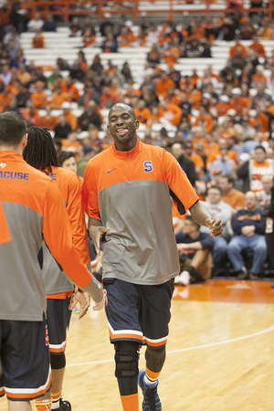 Baye Mouss Keita high fives his teammates in warmups. The senior center missed the Orange's last two games with a right knee sprain and played two minutes in a subdued return on Wednesday night. 