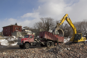 Construction vehicles work on the site of the future Butternut Commons on Syracuse's Northside Tuesday. Demolition of the site's previous buildings began Friday, though no definitive time is set for the project's completion. 