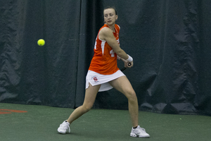 Maddie Kobelt winds up for a backhand. The senior came up big in a critical doubles match to help Syracuse grab its first win of the season on Friday. 