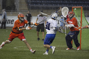 Duke's Jordan Wolf finishes a shot over Bobby Wardwell last Friday in the ACC semifinals. The Orange's defensive breakdowns led to 30 goals allowed in the ACC tournament.