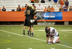 Matt Harris drops to the Carrier Dome turf as Bryant players celebrate their 10-9 upset of Syracuse in the first round of the NCAA tournament Sunday night.