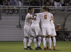 Nick Perea (left) and Juuso Pasanen (center right) celebrate a goal. Rarely in the spotlight, they are the backbone for a nationally ranked Syracuse team.