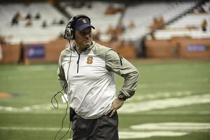 Syracuse head coach Scott Shafer looks on in the Orange's 28-6 loss to Louisville on Friday night. Behind him, few are left in the Carrier Dome seats. 