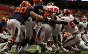 Left tackle Sean Hickey tries to give running back Prince-Tyson Gulley a push forward as the N.C. State defense gains penetration.