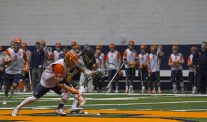 Ben Williams (37) of Syracuse battles Le Moyne during the face-off of a scrimmage on Jan. 24th 2015.