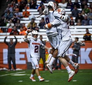 Syracuse celebrates one of its 14 goals against Cornell on Sunday in the Carrier Dome. The SU offense started out slow but gained traction in the second and third quarters to break away from the Big Red. 