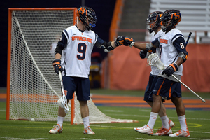 Tim Barber fist-bumps teammates in Syracuse's 18-5 blowout win over rival Hobart on Tuesday in the Carrier Dome.