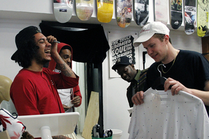 Drew Shoup (left), a co-owner of Better Skate Shop, interacts with customers. He said the shop attracts Syracuse University students and residents who support the city’s artistic subculture.