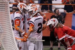 Kevin Rice (2) celebrates with teammates following a Syracuse goal. He had a career-high nine points in the blowout win over Marist. 