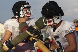 Freshman Eric Dungey (left) battled sophomore Austin Wilson in a pugil fight on Tuesday. Head coach Scott Shafer said they're competing for the backup quarterback spot on Wednesday.