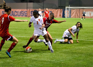 Sophomore Sheridan Street tries to find space against two St. John's defenders. The Orange struggles to make use of its second-half chances in a 1-0 loss to St. John's.