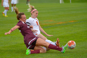 Jackie Firenze slides toward the ball with a Colgate player. Firenze came off the bench for the first time this season instead of starting the game.