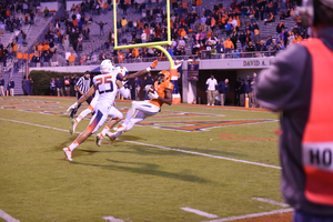 Canaan Severin (9) catches a touchdown for Virginia in the first overtime period. The Cavaliers overcame a 10-point deficit to defeat SU in triple overtime.