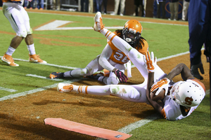 UVA's Maurice Canady looks on as an SU player falls out of bounds with the ball.