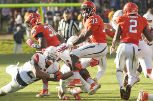 Syracuse defenders pursue Virginia's Olamide Zaccheaus (33). The Orange fell to the Cavaliers in triple overtime on Saturday afternoon.