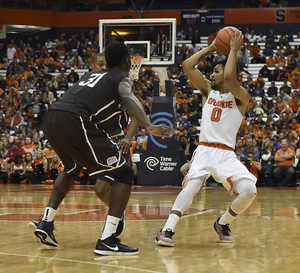 Michael Gbinije, Syracuse's 6-foot-7 point guard, said he wants to post up smaller guards this season. Doing so successfully requires help from his teammates. 