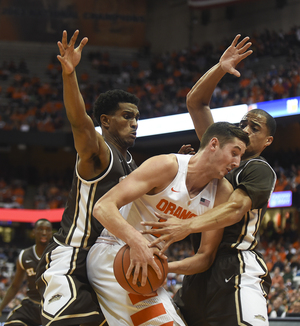 Tyler Lydson shields the ball from two St. Bonaventure players in the Orange's win over the Bonnies on Tuesday night.