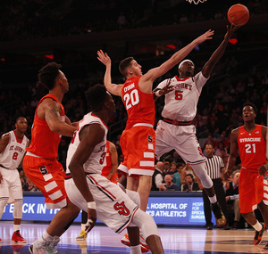 Durand Johnson drives past Tyler Lydon and attempts a layup.