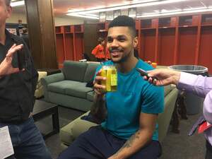 Michael Gbinije drinks pickle juice in front of reporters in the Syracuse locker room. 