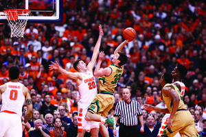 Tyler Lydon reaches up to defend a Notre Dame player. Syracuse beat the Fighting Irish by 15 on Thursday night.