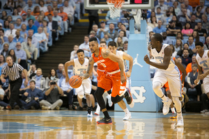 Michael Gbinije dribbles down the court at Syracuse's matchup with No. 7 North Carolina. Gbinije had 17 points to lead the Orange 