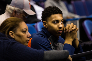 Annette Moyer (left) and her son Matthew, a Syracuse basketball signee, watch the Orange's open practice on Thursday at the Scottrade Center in St. Louis.