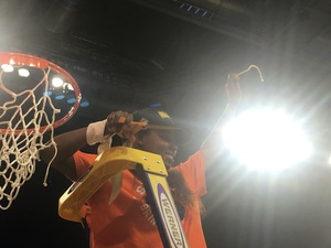 Alexis Peterson raises a snippet of the net after Syracuse advanced to the Final Four for the first time in program history.