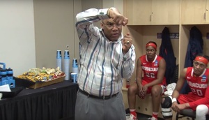 Syracuse head coach Quentin Hillsman explains to his team how to cut down the nets in the locker room after advancing to the Elite Eight.