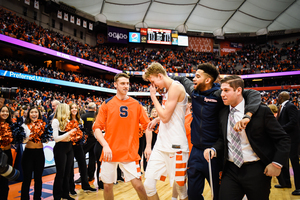 Marek Dolezaj, center, walks off the floor after helping Syracuse beat a ranked opponent for the first time this season.