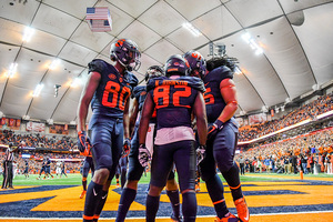 Nykeim Johnson celebrates his 82-yard touchdown reception with his teammates on Saturday night.