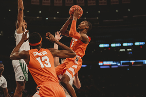 Jalen Carey hangs in the air with the ball.