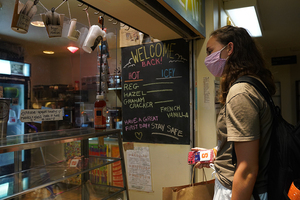 Kendra Miller, a freshman at Syracuse University, orders a drink at People's Place.