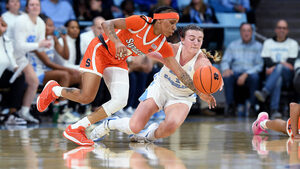 Alyssa Ustby (right) recorded the first triple-double in North Carolina history, spearheading a 75-51 blowout of No. 25 Syracuse. 