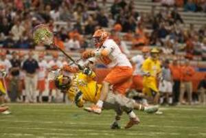 Kenny Nims levels Siena goalie Brent Herbst in Syracuse's victory over the Saints Sunday.