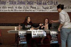 Elizabeth Watson (left) and Emily Robinson, a sophomore exercise science major and a junior acting major, respectively, sell bracelets to raise money for the White Ribbon campaign and to promote Take Back the Night, which both call attention to sexual violence.