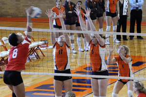 Members of the SU volleyball team line up at the net to counter St. John's attack.